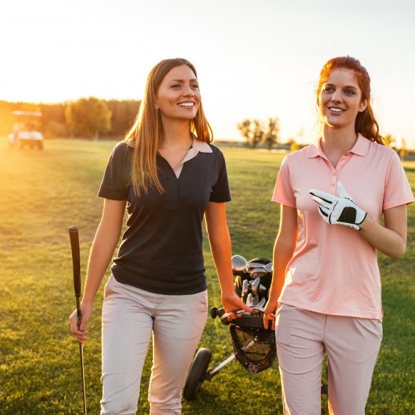 Two women walking on the golf coarse